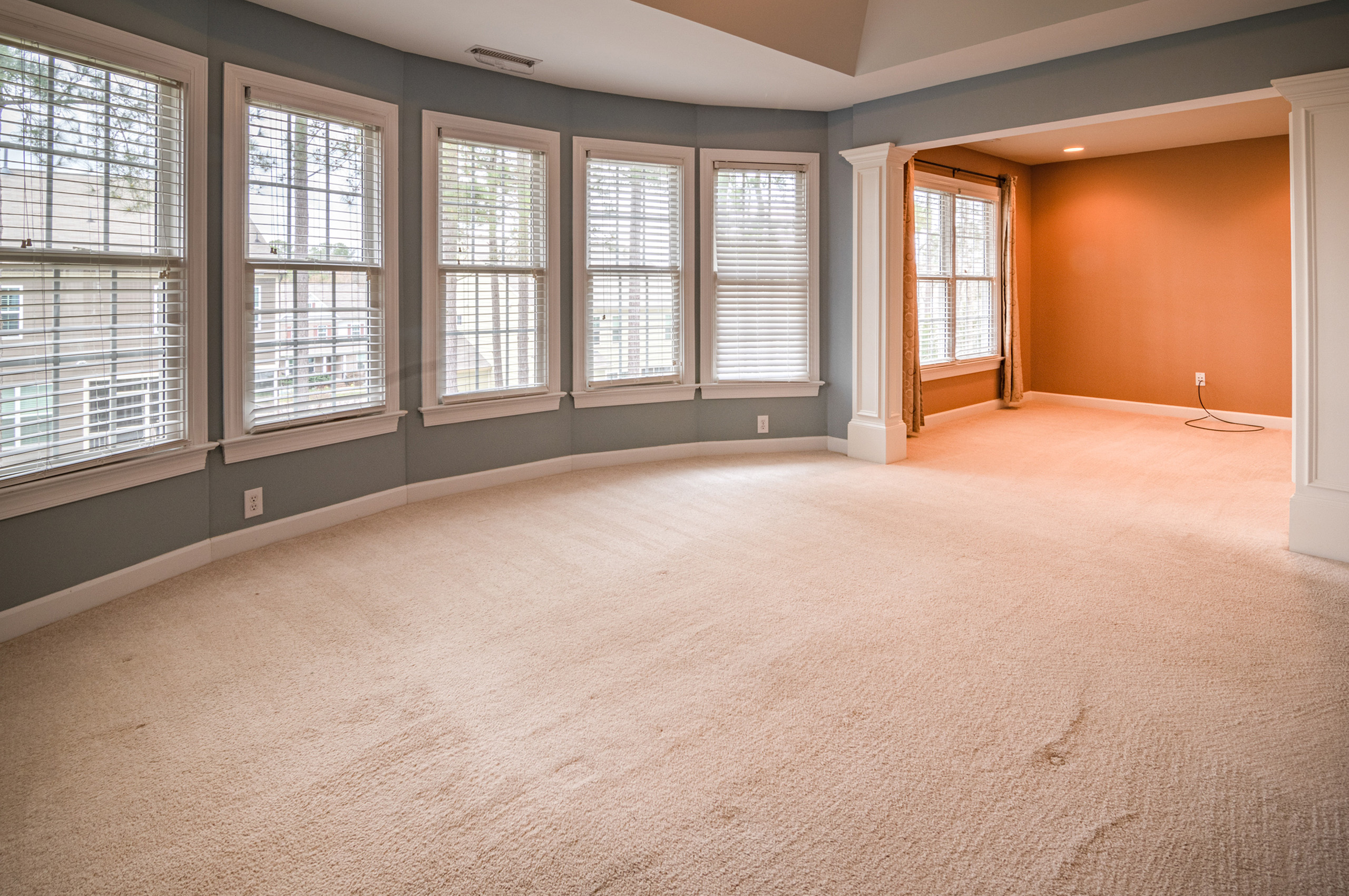 living-room-with-plenty-windows-and-carpeted-floor-3990587 2